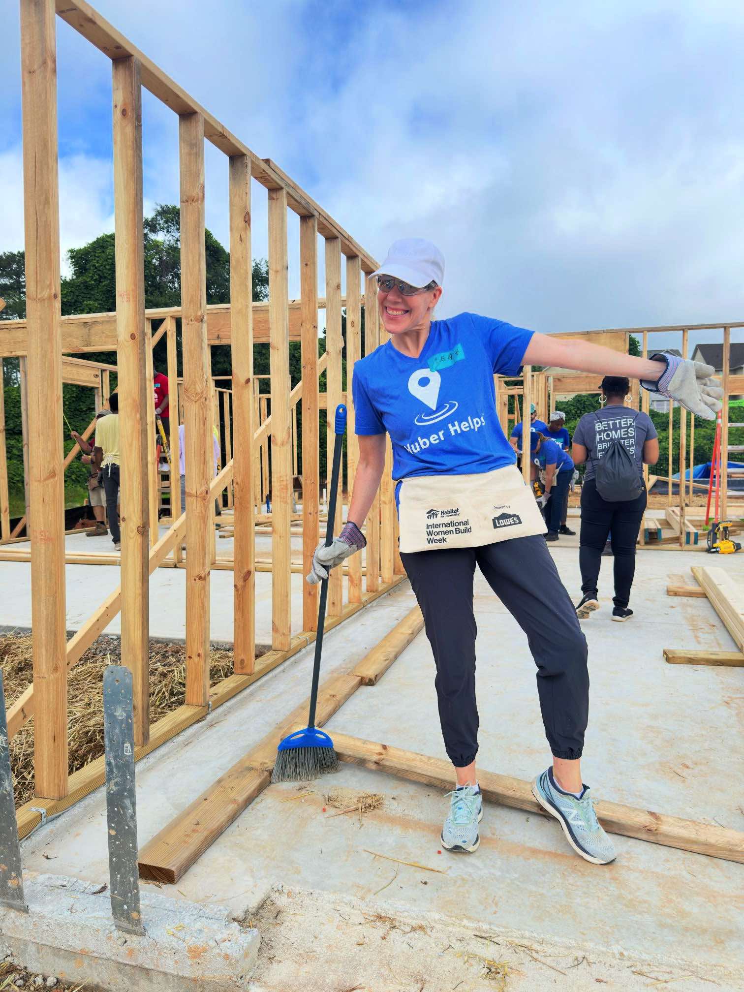 A member of the Huber team helps with cleanup on a home build.