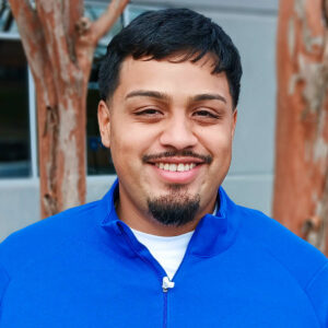 A photo of Kevin Garcia, our Assistant Construction Manager, outside of the Gwinnett/Walton Habitat for Humanity offices.