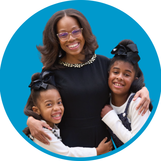Danelle and her two children hug at their home dedication